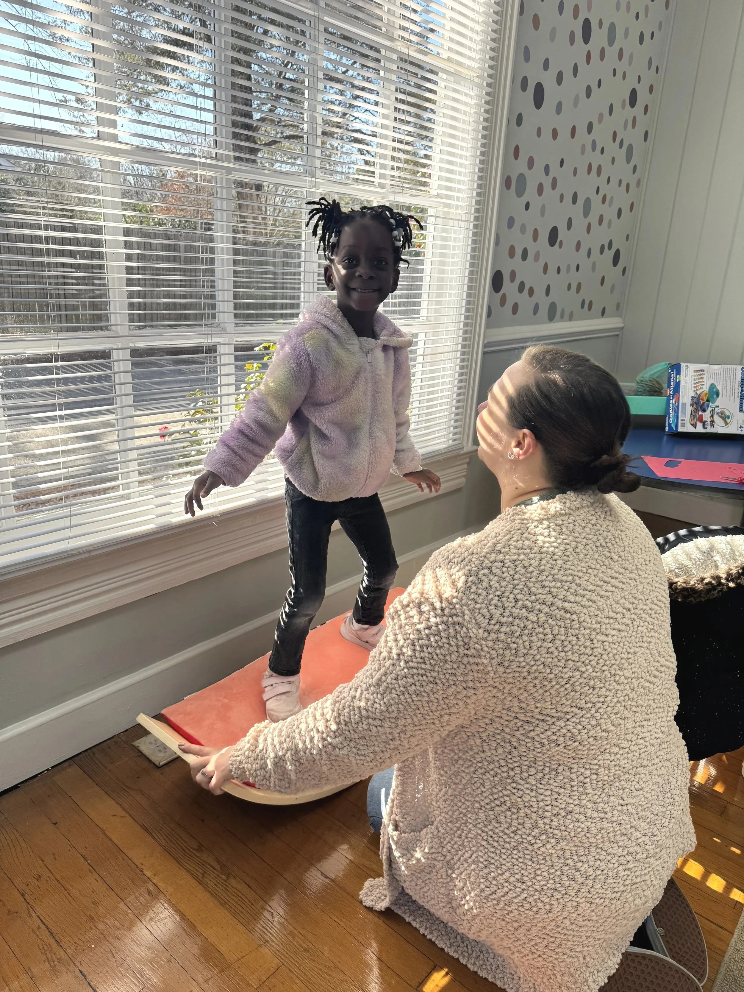 Child on rocking board therapy
