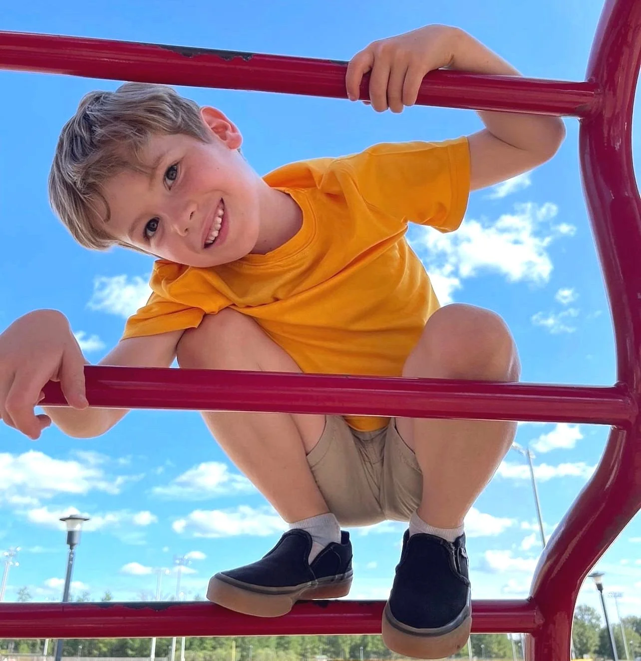 Child climbing playground equipment